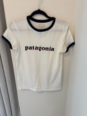 Women’s size small Patagonia White Tee with Navy Trim and Multicolor Logo